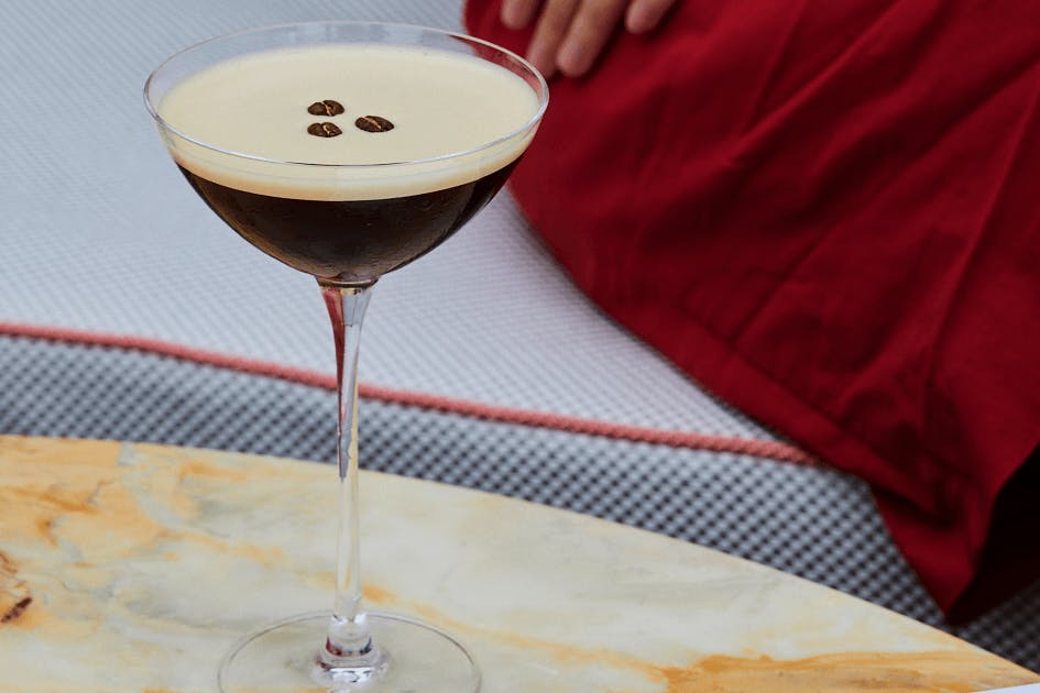 An espresso martini on a marble table.